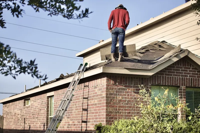 Professional roofer working on a residential roof in River Grove on The Trail